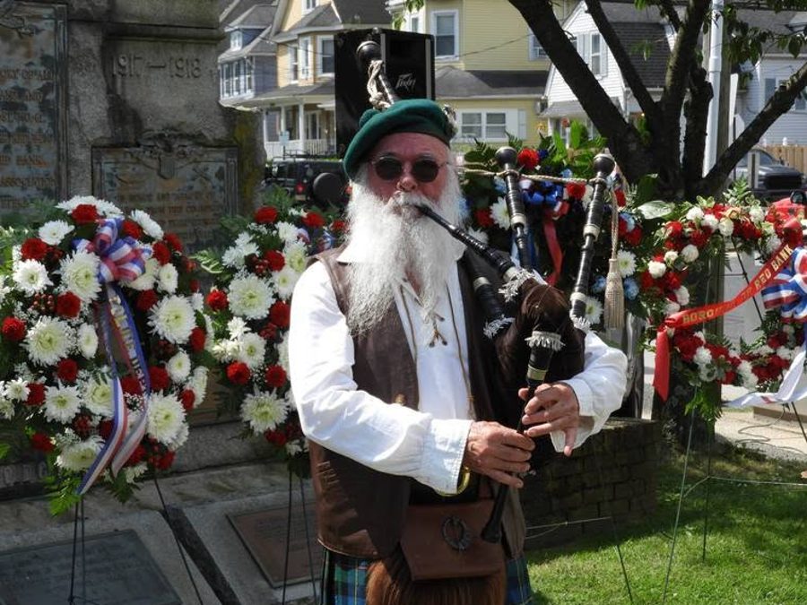 A solo piper performing at a memorial ceremony